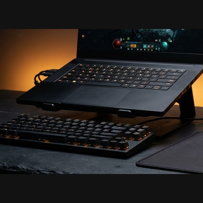 Vector mechanical keyboard in front of a laptop